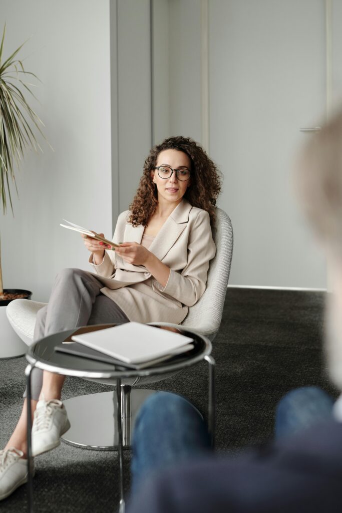 pexels photo 4344106 4344106 A professional woman in an office setting conducting an interview with confidence.